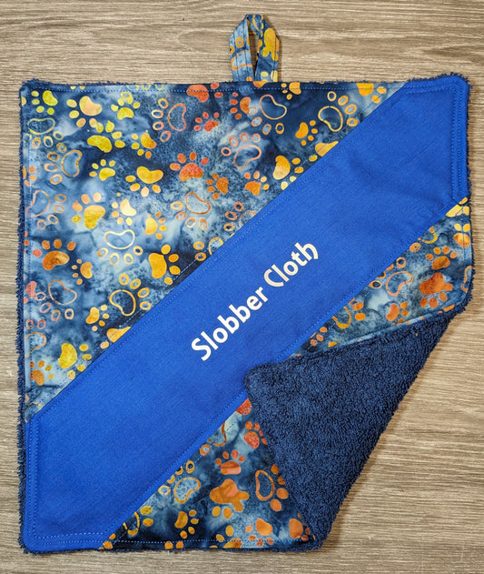 Slobber Cloth. Wipe that Slobber in style! Navy toweling / batik blue, tan, green tones on variegated blue with paw print and royal blue cotton. Dog Doiley! Drool wiper. Washable. Essential for slobbery breeds!