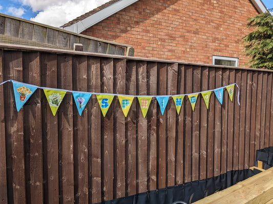 Spring Bunting -sunshine yellow, lime green, sky blue with flowers and the word SPRING in checked pattern.
